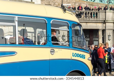 BRIGHTON, EAST SUSSEX/UK - NOVEMBER 1 : Chris Evans Driving an Old Bus approaching the Finish Line of the London to Brighton Veteran Car Run on November 1, 2015. Unidentified people.