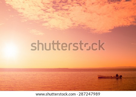Fishing boat at Sunset in the Sea blurred