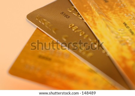 Photo of three gold credit cards.