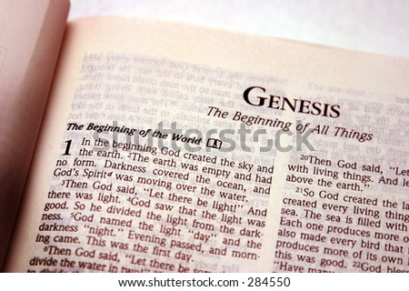 Photo of the bible opened to the book of genesis.