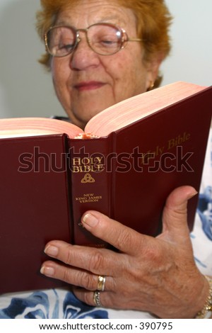 Photo of a senior woman reading the bible.