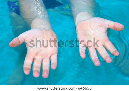 Photo of hands in the water.