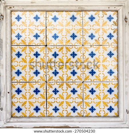 Old wall tiles azulejos into wooden frame.