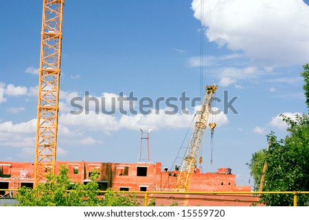 Two construction cranes in operation