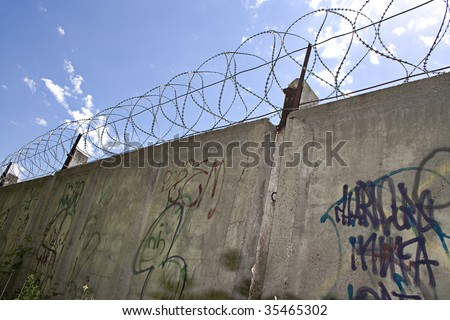Barbed wire wall and blue sky