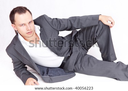 Portrait of business male model lays. Relaxing.