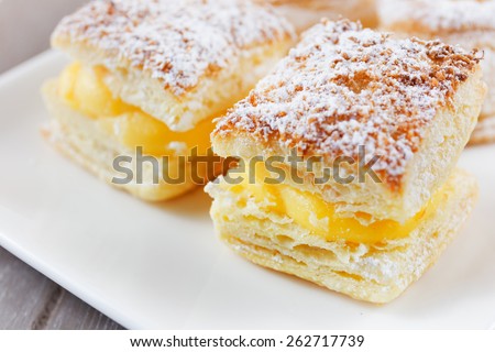 Square of cream-covered baked sugar on white font