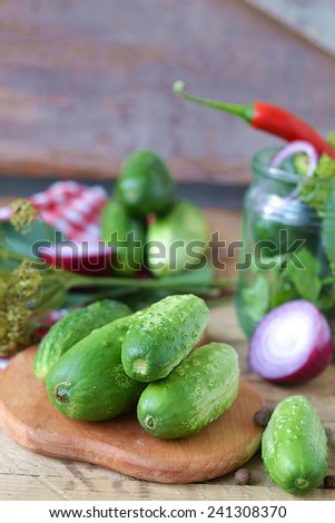 Set for home canning cucumbers on a background of onion, dill, parsley, red pepper.Selective focus