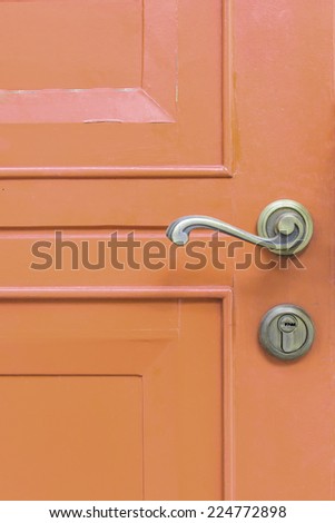 classic door handle on orange door