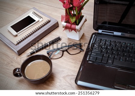Laptop and cup of coffee with flower on desk, Vintage style