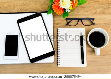 Laptop, Tablet and cup of coffee with flower on desk