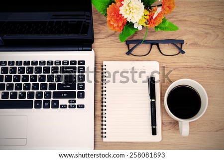 Laptop and cup of coffee with flower on desk, Vintage style