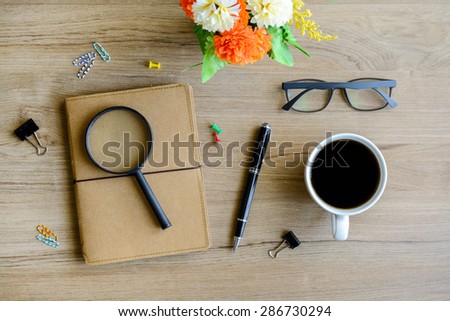 Cup of coffee with notebook on desk, workplace