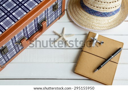 vintage suitcase and diary on white wooden background, Travel concept