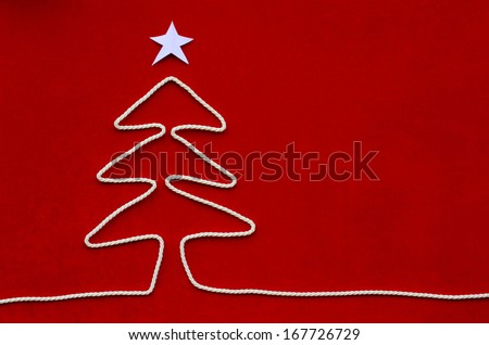Christmas tree shaped rope on red velvet background