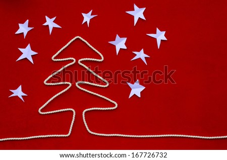 Christmas tree shaped rope on red velvet background
