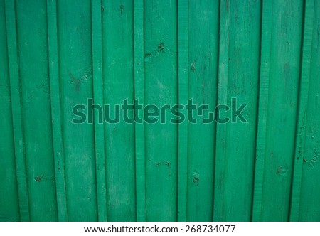 Wooden Palisade background. Close up of green wooden fence panels.