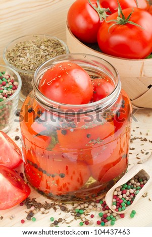 Homemade tomatoes preserves in glass jar. Canned tomatoes.