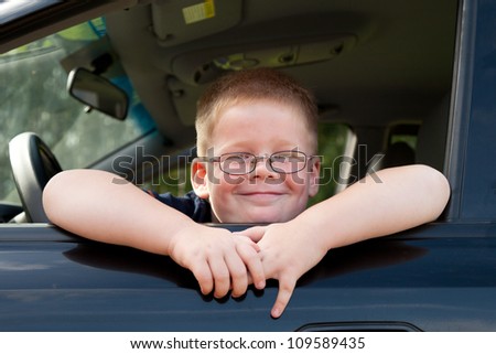 little boy car driver behind the wheel