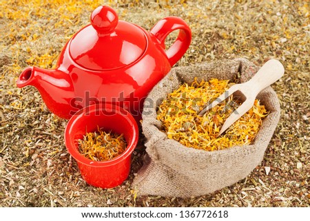 bag with healing herbs and red tea kettle, herbal medicine