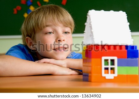 The boy with small house from blocks