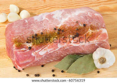 raw meat with spice,  pork on gutting board - ready to cook
