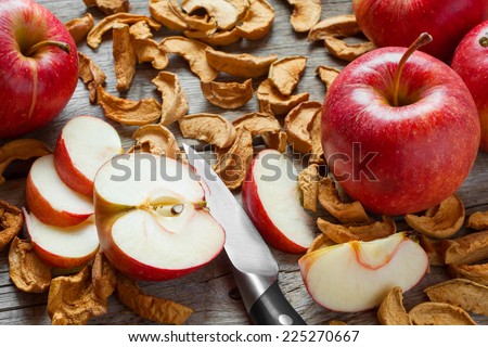 dried apple slices and red fresh red apple fruit on old wooden kitchen table