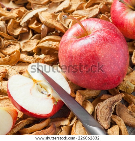 dried apple slices, knife and red fresh red apple fruit close up