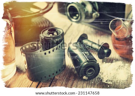Old photo film rolls, cassette, retro camera and chemical reagents for photographic film. Vintage stylized.