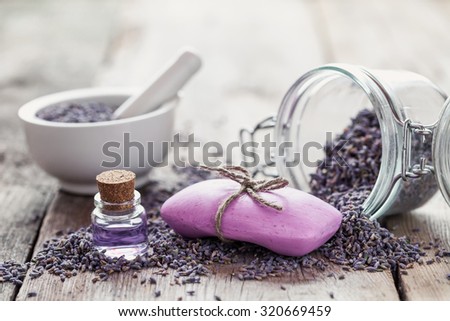 Bars of homemade soaps, dry lavender flowers and essential oil. Selective focus.