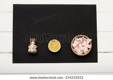 Air candy with lemon on black, shabby Board