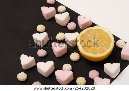 Air candy with lemon on black, shabby Board