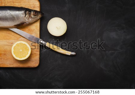 Herring with lemon and onions on a cutting Board