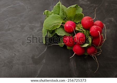 Beam, juicy, ripe radish on a black table
