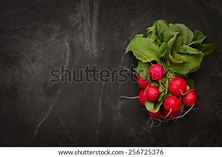 Beam, juicy, ripe radish on a black table