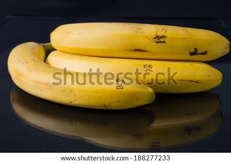 A bunch of bananas with mean faces.