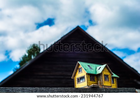 the layout of the house on a background of a large wooden house