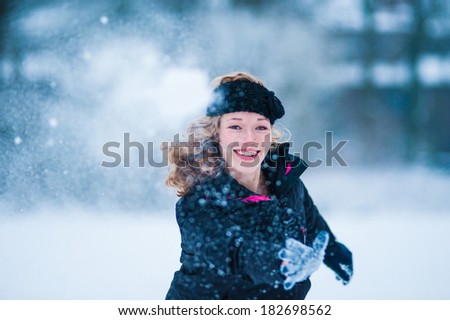Girl throwing snow ball