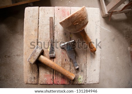 a tool bench with hammers, sticks, iron chisel and with the view from above