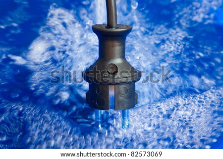 With hydropower generated renewable energy - power plug and blue water