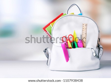 Back to school.Backpack with school supplies empty space background.