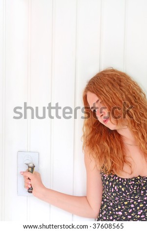 Sad red-haired girl near the door