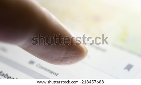 Slightly defocused and closeup of finger touching and pointing on screen of digital display screen