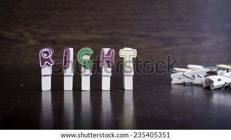 Common business terms - Slightly defocused and close-up of RIGHT word on clothes peg stick with lots of clothes peg at background