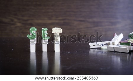 Common business terms - Slightly defocused and close-up of SET word on clothes peg stick with lots of clothes peg at background