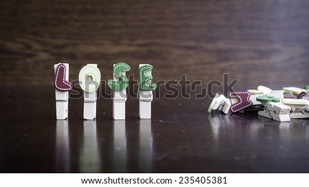 Common business terms - Slightly defocused and close-up of LOSE word on clothes peg stick with lots of clothes peg at background
