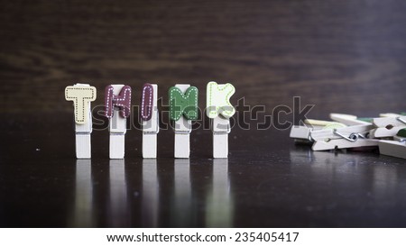 Common business terms - Slightly defocused and close-up of THINK word on clothes peg stick with lots of clothes peg at background