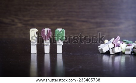 Common business terms - Slightly defocused and close-up of FUN word on clothes peg stick with lots of clothes peg at background