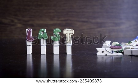 Common business terms - Slightly defocused and close-up of LAST word on clothes peg stick with lots of clothes peg at background