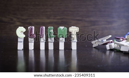 Common business terms - Slightly defocused and close-up of CLIENT word on clothes peg stick with lots of clothes peg at background